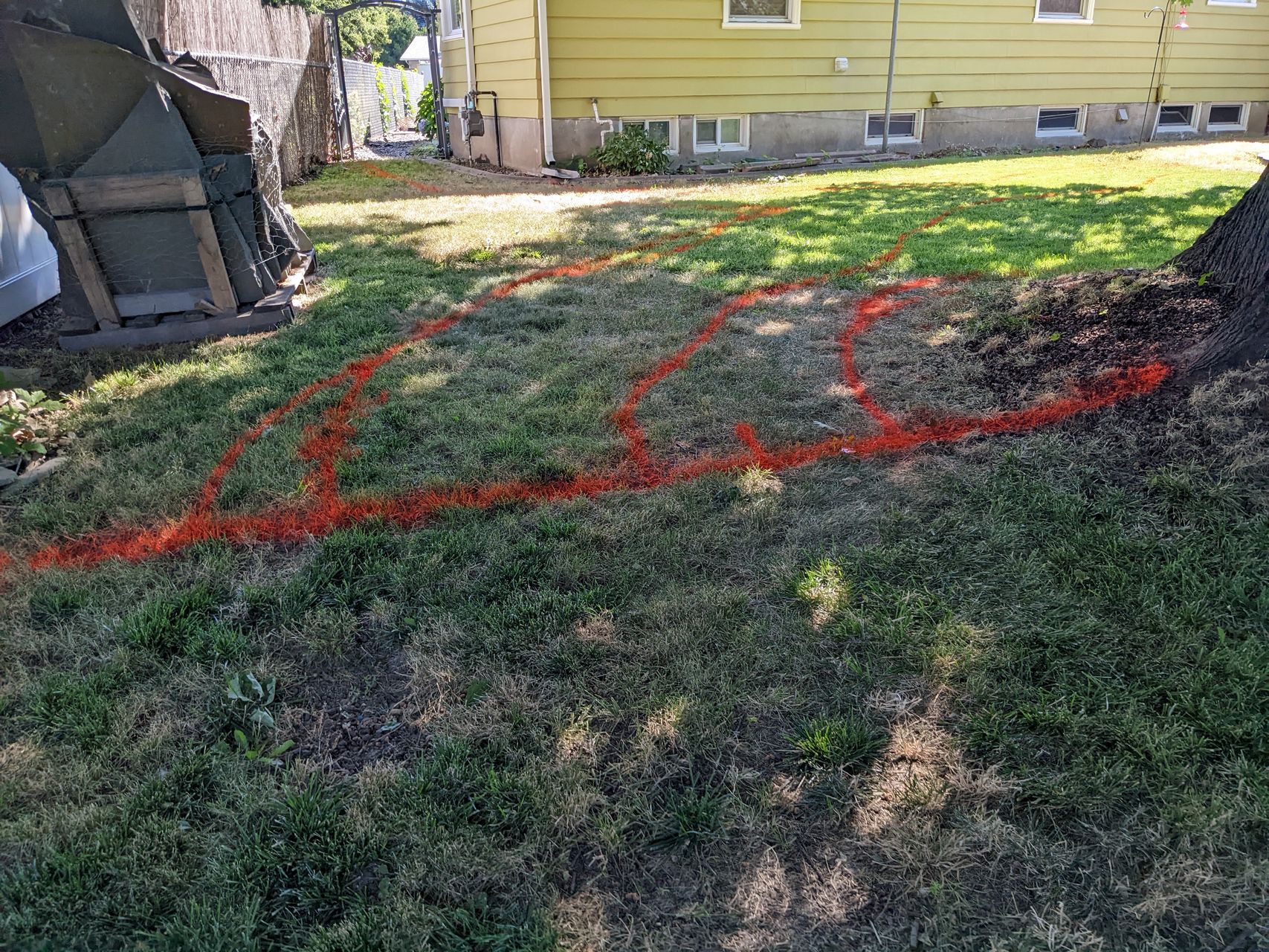 paint on the lawn showing where paths should go